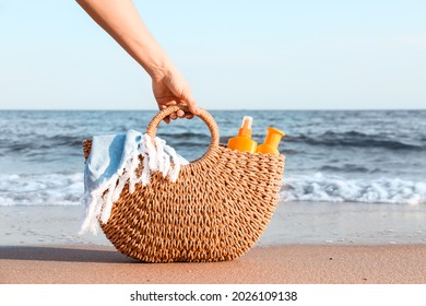 Woman With Sunscreen Cream In Bag On Beach