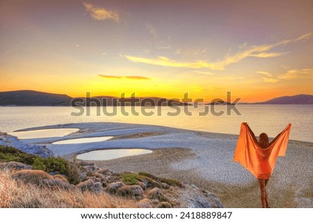 A woman at the sunset at the beach Megali Ammos of Marmari in Evia, Greece