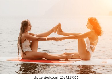 Woman sup yoga. Happy sporty woman practising yoga pilates on paddle sup surfboard. Female stretching doing workout on sea water. Modern individual female hipster outdoor summer sport activity. - Shutterstock ID 2367219335