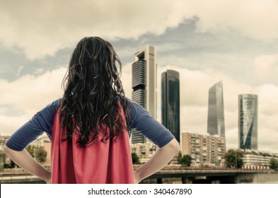 Woman Superhero With Red Cape In The City. Vintage Color. 