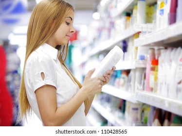 Woman In A Supermarket Reading The Label Behind A Package