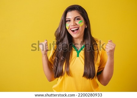 Woman supporter of Brazil, football championship, screaming goal, celebrating team victory and goal.