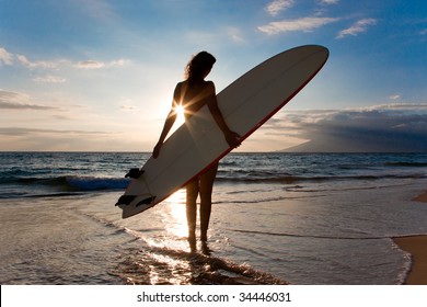 woman with surfboard and shinning sun light