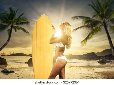 WOman with surfboard at the tropical  beach