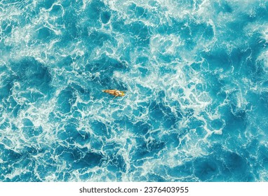 Woman surfer in a deep ocean on a short surfboard in Hawaii aerial - Powered by Shutterstock