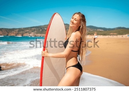 Similar – Image, Stock Photo Young surfer woman in bikini going surfing stands with surfboard on the black sandy beach. Girl walks with longboard. Extreme water sport by the ocean, sea. Healthy Active Lifestyle. Summer Vacation