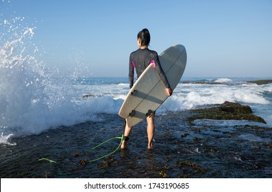 Woman Surfer With Surfboard Going To Surf On Seaside