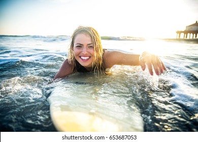 Woman surfing in the ocean - Shutterstock ID 653687053