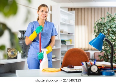 Woman In Surgical Scrubs And Rubber Gloves Cleaning Floor With Mop In Hospital.