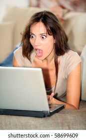 Woman With Surprised Look In Front Of Computer