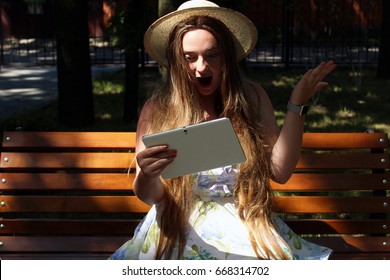 woman is surprised when looking on the tablet - Shutterstock ID 668314702