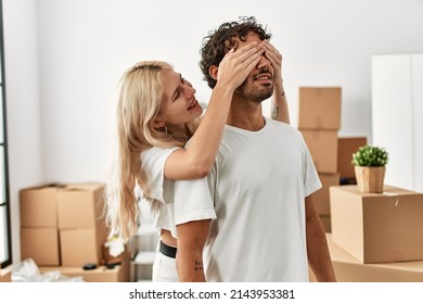 Woman surprising hes boyfriend covering eyes at new home.