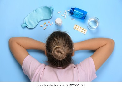 Woman Surrounded By Different Pills On Turquoise Background, Top View. Insomnia Treatment
