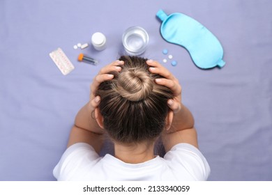 Woman Surrounded By Different Pills On Bedsheet, Top View. Insomnia Treatment