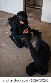 Woman Swat Police Officer Arresting A Criminal Guy With A Gun.