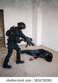 Woman Swat Police Officer Arresting A Criminal Guy With A Gun.