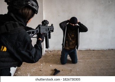 Woman Swat Police Officer Arresting A Criminal Guy With A Gun.