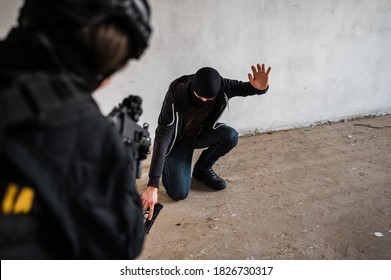 Woman Swat Police Officer Arresting A Criminal Guy With A Gun.