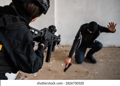 Woman Swat Police Officer Arresting A Criminal Guy With A Gun.