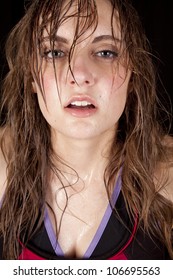 A Woman With Sweat Running Down Her Face After A Workout.