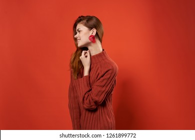 a woman in a sweater and beautiful earrings                   - Shutterstock ID 1261899772