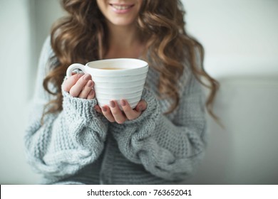 Woman In A Sweater Drinking Tea 