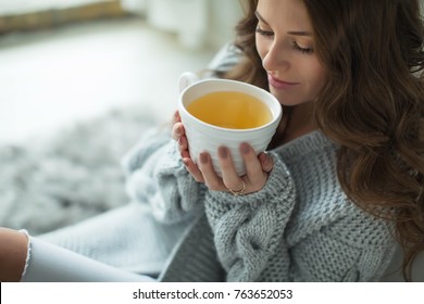 Woman In A Sweater Drinking Tea 