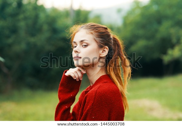 Woman in a
sweater red hair nature cropped
look