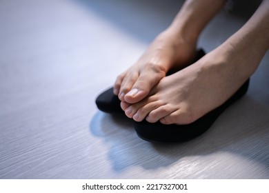 Woman Sweaty Feet On Shoes On Hardwood Floor