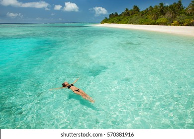 Woman Swim And Relax In The Sea. Happy Island Lifestyle. White Sand, Crystal-blue Sea Of Tropical Beach. Vacation At Paradise. Ocean Beach Relax, Travel To Maldives Islands