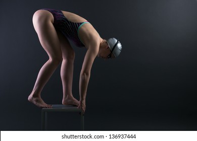 Woman swimmer prepared to jump into the water. - Powered by Shutterstock