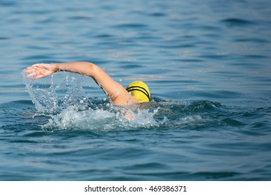 Woman Swimmer Swimming Crawl In Blue Sea