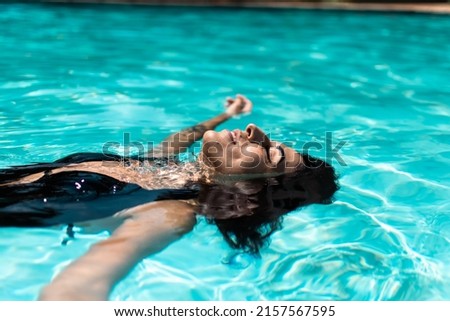 Similar – Brunette surfer woman in bikini standing with surfboard