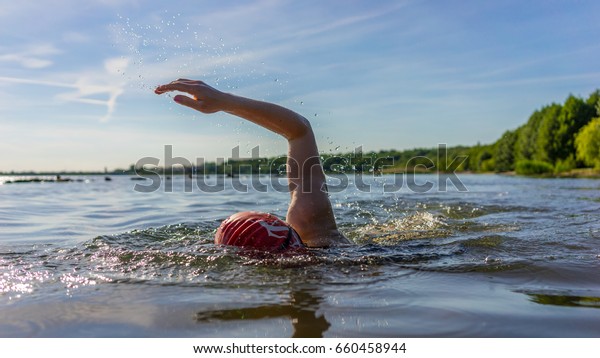 Woman swimming in a\
lake