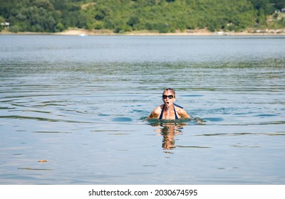 Woman Swimming In Open Water Lake