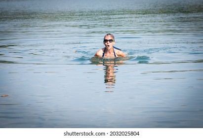 Woman Swimming In Open Water Lake