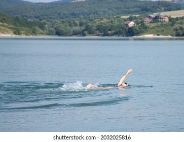 Woman Swimming In Open Water Lake