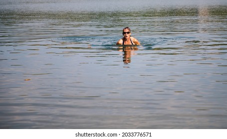 Woman Swimming In Open Water Lake