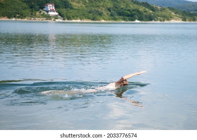 Woman Swimming In Open Water Lake