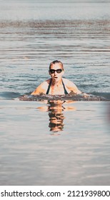 Woman Swimming In Open Water Lake