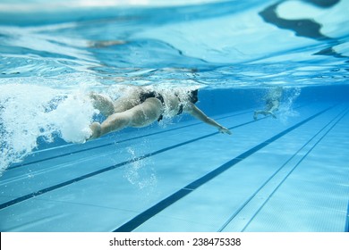 Woman Swimming In Outdoor Pool 