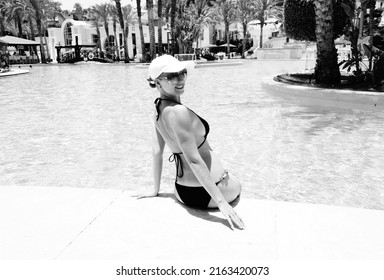  woman in the swimming pool, resort black and white picture             