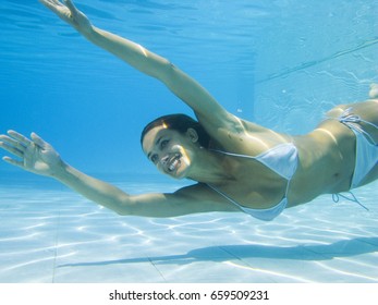 Woman Swimming In A Pool Under Water