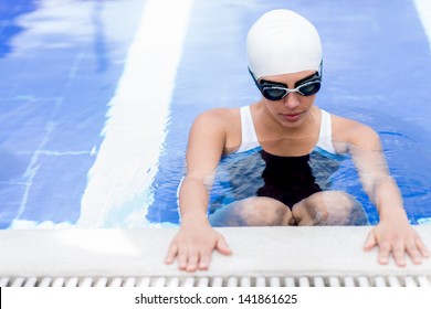 Woman In The Swimming Pool Working Out