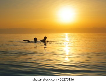 Woman Swimming In Salty Water Of A Dead Sea