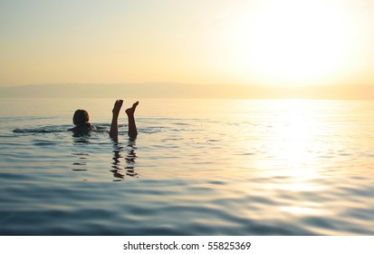 Woman Swimming In Salty Water Of A Dead Sea