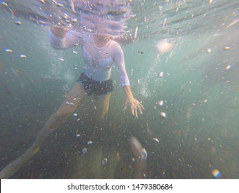 Woman Swimming Underwater With Clothes With Her Head Outside. Gopro