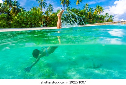 Woman swimming underwater, diving in turquoise transparent sea, wonderful tropical nature, summer adventure and tourism concept