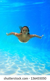 Woman Swimming Underwater At The Pool