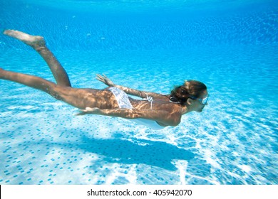 Woman Swimming Underwater In A Swimming Pool